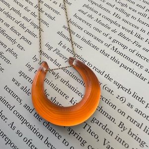 Gold-tone Alexis Bittar lucite horseshoe pendant necklace with lobster clasp